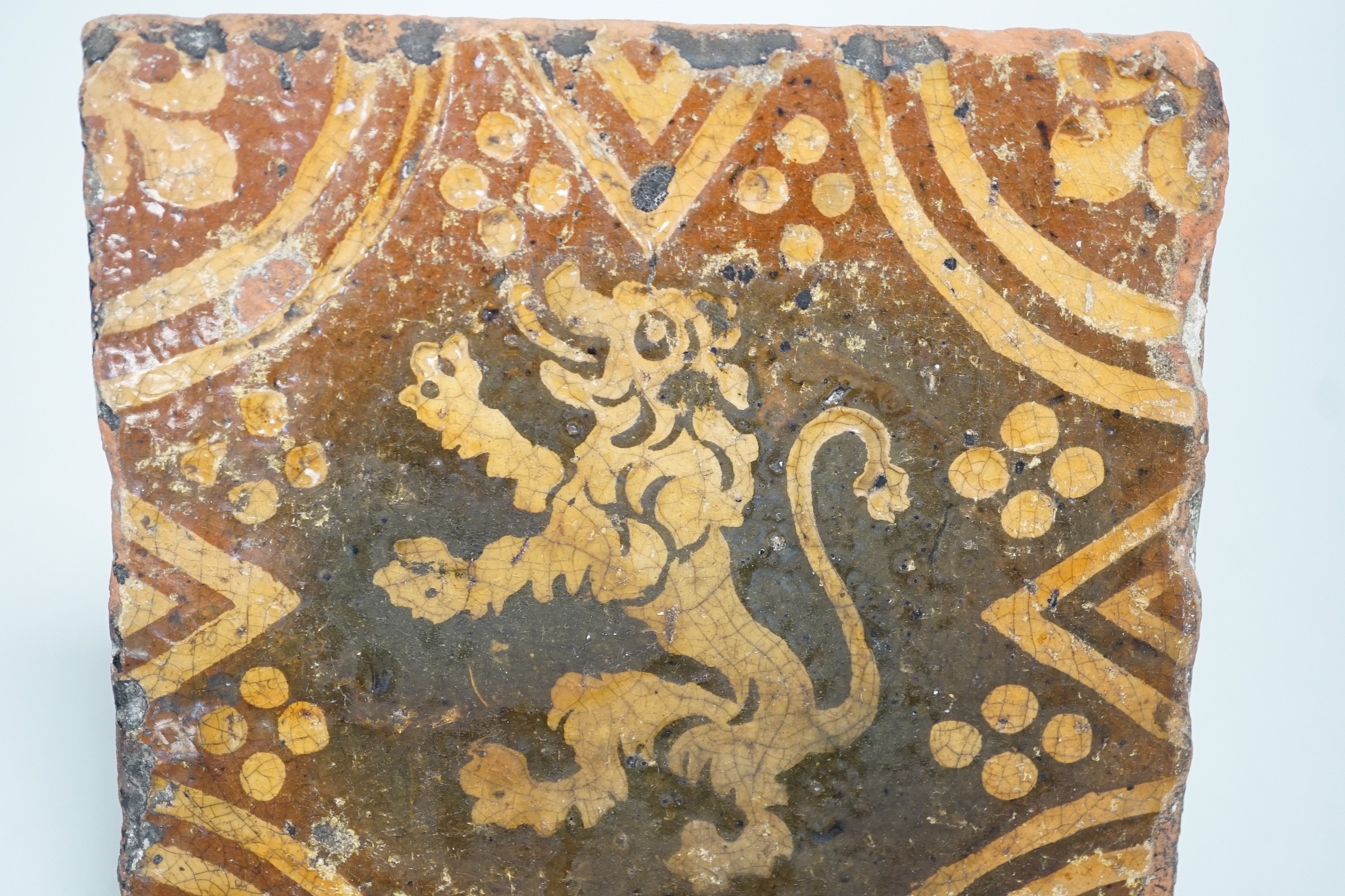 A single early ecclesiastical floor tile with rampant lion detail. 14 x 14cm